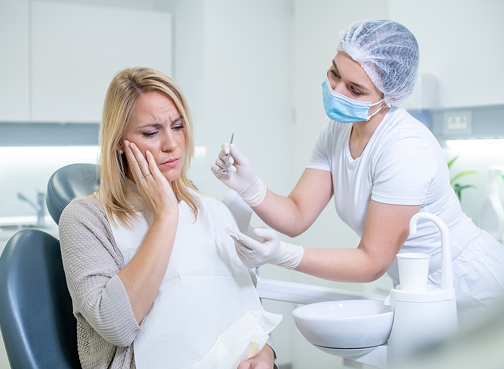 Dentist examining woman with toothache